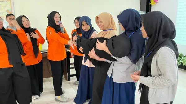 Petugas BPBD Kabupaten Sukabumi memberikan pelatihan teknik evakuasi kepada siswa baru saat kegiatan simulasi penanggulangan bencana dalam kegiatan MPLS SMA Albayan Putri Salabintana, Kamis (17/6/2025). (Sumber Foto: Dok. BPBD)