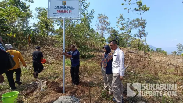 Petugas dari BPKAD bersama Anggota Satpol PP Kabupaten Sukabumi saat memasang plang aset di Kampung Cikeong, Palabuhanratu, Jumat (1/8/2025). (Sumber Foto: SU/Ilyas)