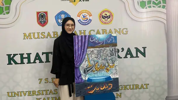 Salwa Sadiah dan karya kaligrafinya saat mengikuti ajang Musabaqah Tilawatil Qur’an Mahasiswa Nasional (MTQMN) 2025 dalam kategori Khattil Qur’an Kontemporer Putri di Banjarmasin. (Sumber Foto: Dok. NPU)