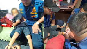 Bocah 5 tahun asal Palabuhanratu yang kaki kananya terborgol dan sedang dibantu oleh Petugas Damkar (Sumber : Istimewa.).