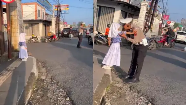 Aiptu Jajat Sudrajat, Anggota Polantas Polres Sukabumi Kota saat bertugas sambil temani anak | Foto : Capture video warga