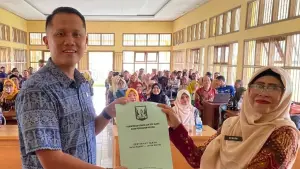 Sekretaris Disdik Kabupaten Sukabumi, Herdiawan Waryadi, menyerahkan SK kenaikan pangkat guru kepada tenaga pendidik dari 47 kecamatan. (Sumber: Istimewa)